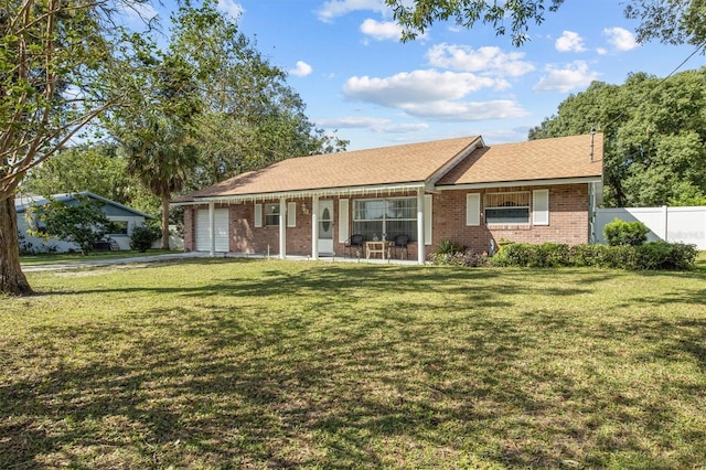 ranch-style home with a garage and a front lawn