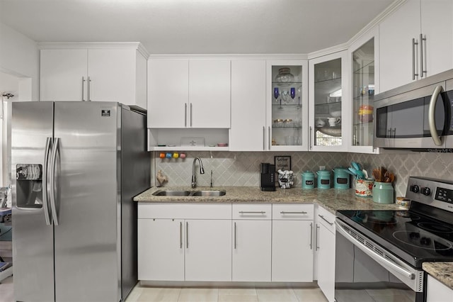 kitchen featuring decorative backsplash, sink, light stone counters, stainless steel appliances, and white cabinets