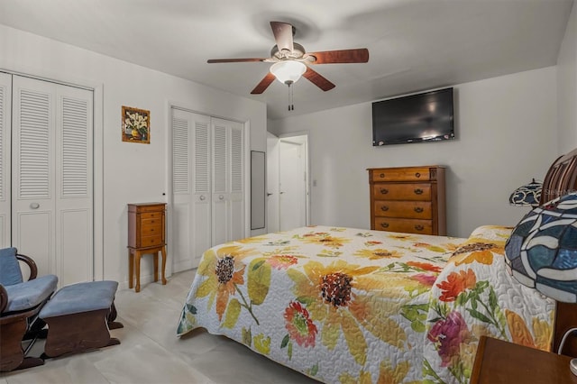 bedroom featuring ceiling fan and two closets