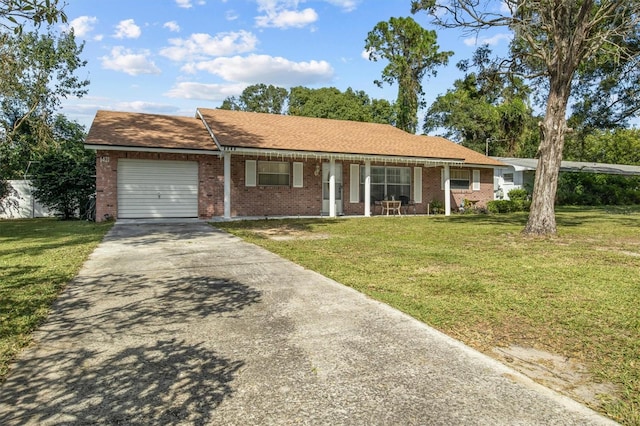 ranch-style home featuring a porch, a front yard, and a garage