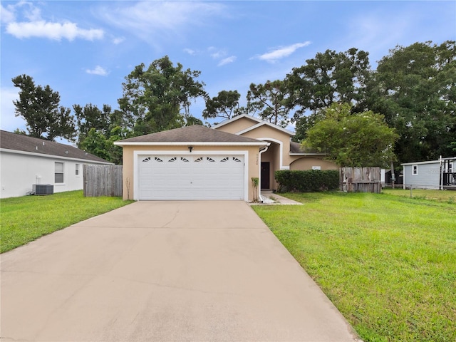 view of front of home featuring a garage, central AC unit, and a front yard