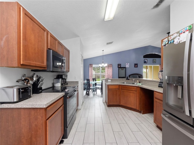 kitchen featuring appliances with stainless steel finishes, kitchen peninsula, lofted ceiling, decorative light fixtures, and a chandelier