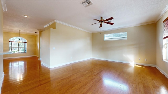 spare room featuring light hardwood / wood-style flooring, ornamental molding, and plenty of natural light