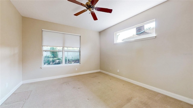 empty room featuring light carpet and ceiling fan