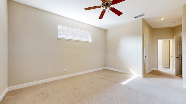 spare room with light carpet and ceiling fan