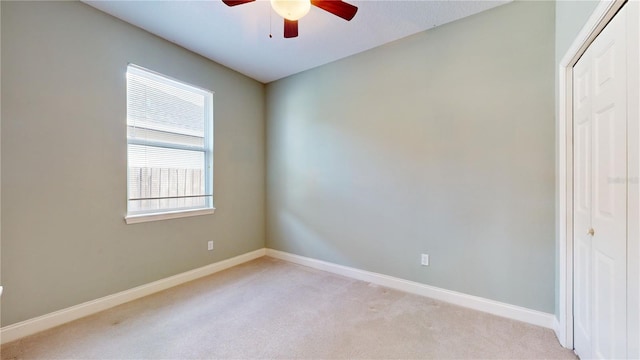 empty room with light carpet and ceiling fan