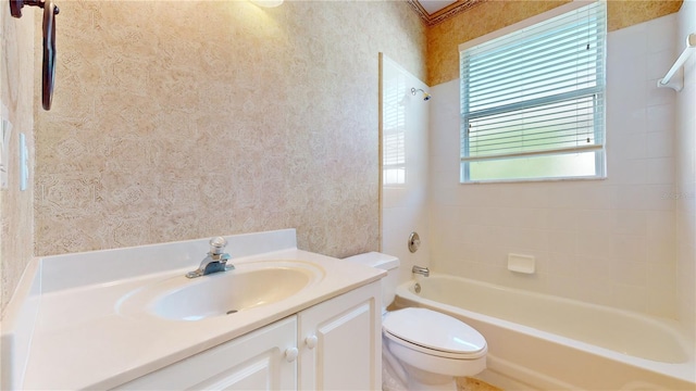 full bathroom featuring tiled shower / bath, vanity, and toilet