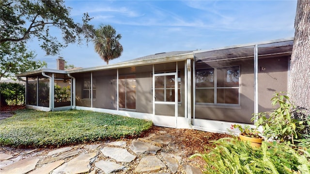 back of property featuring a sunroom