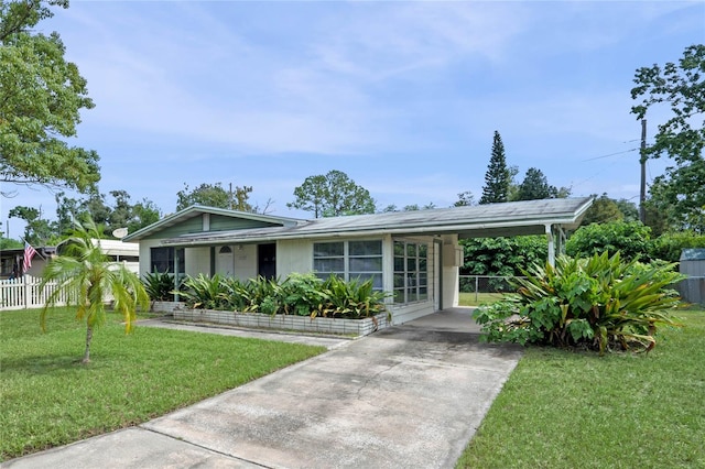 single story home featuring a front yard and a carport