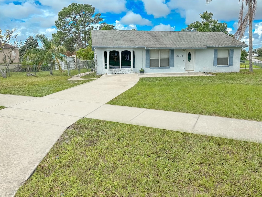 ranch-style house with a front lawn