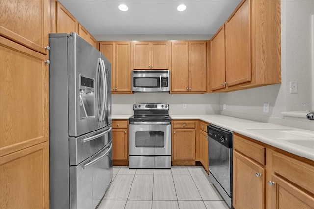 kitchen with stainless steel appliances and light tile patterned floors