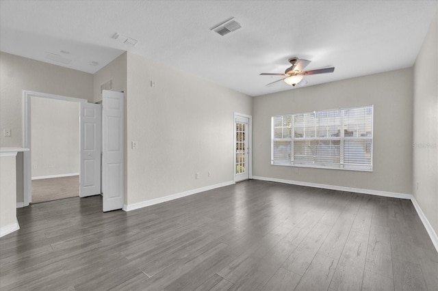 spare room featuring ceiling fan and dark hardwood / wood-style flooring