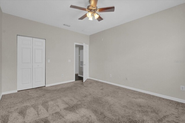 unfurnished bedroom with a closet, carpet floors, and ceiling fan