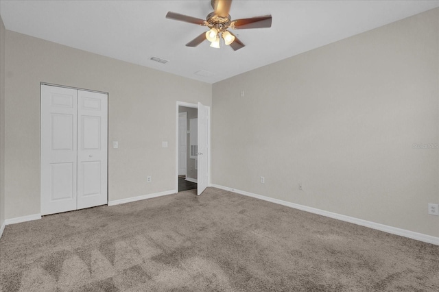 unfurnished bedroom with carpet flooring, baseboards, ceiling fan, and visible vents