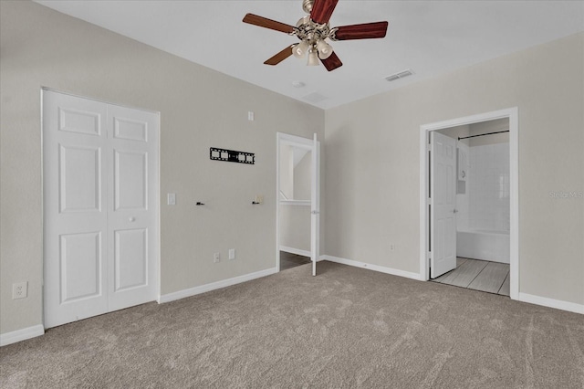 unfurnished bedroom with connected bathroom, light carpet, and ceiling fan