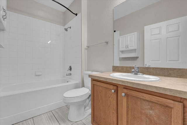 full bath with shower / tub combination, vanity, and toilet