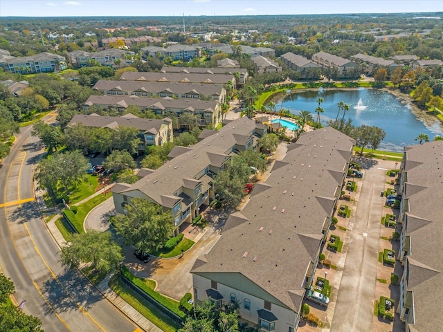 drone / aerial view featuring a water view and a residential view