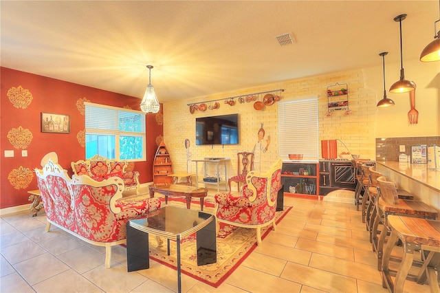 living room with light tile patterned floors and brick wall