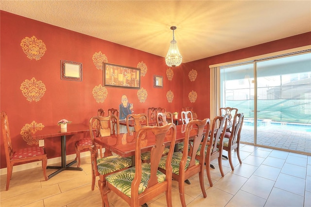 tiled dining room featuring a notable chandelier