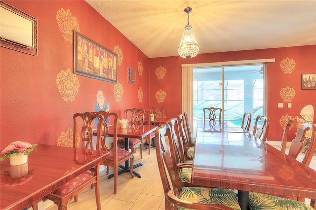 tiled dining space featuring a chandelier