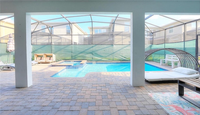 view of pool featuring an in ground hot tub, a patio, and a lanai