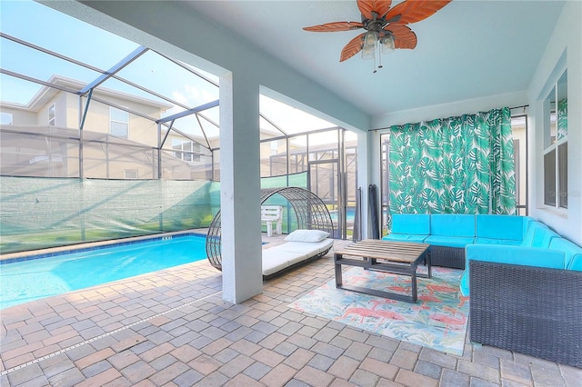 view of pool featuring a lanai, outdoor lounge area, ceiling fan, and a patio