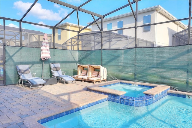 view of swimming pool featuring an in ground hot tub, glass enclosure, and a patio area