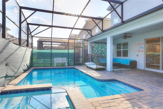 view of pool featuring glass enclosure, ceiling fan, and a patio