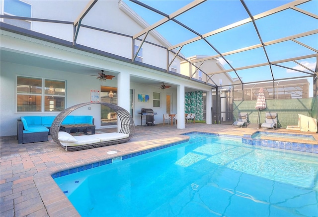 view of pool with glass enclosure, ceiling fan, and a patio area