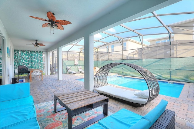 view of patio featuring outdoor lounge area, ceiling fan, and a lanai