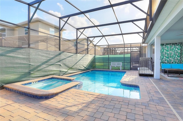 view of swimming pool featuring glass enclosure, an in ground hot tub, and a patio