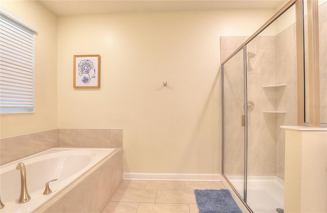 bathroom featuring tile patterned floors and shower with separate bathtub