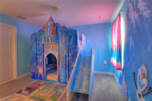 carpeted bedroom featuring a textured ceiling