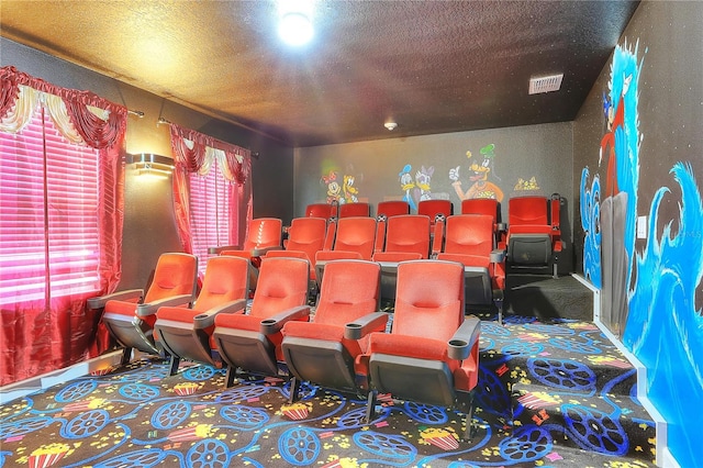 carpeted home theater featuring a textured ceiling