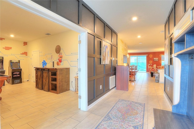 hall with light tile patterned floors