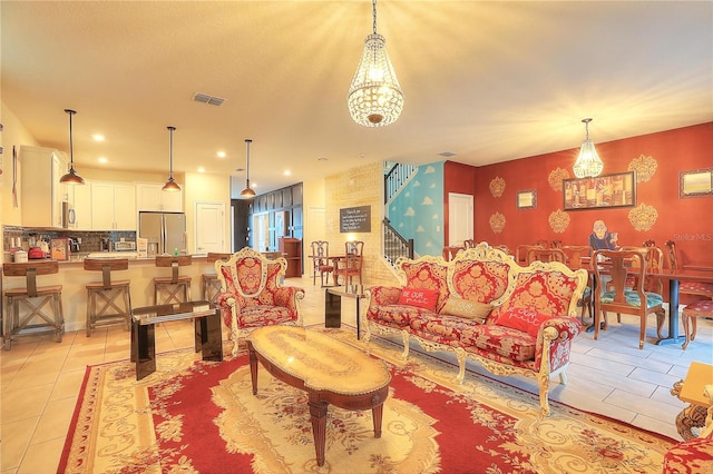 living room featuring light tile patterned flooring and a notable chandelier