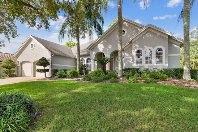 view of front of home featuring a garage and a front lawn