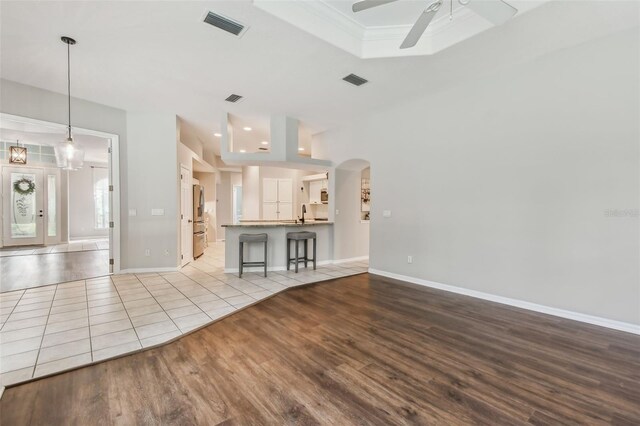 unfurnished living room featuring ceiling fan and light hardwood / wood-style flooring