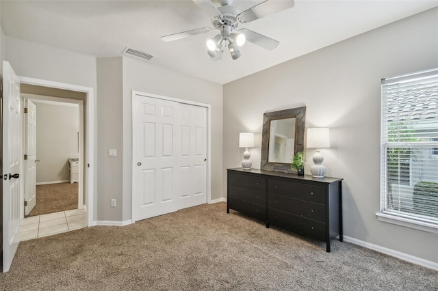 bedroom with light carpet, a closet, and ceiling fan