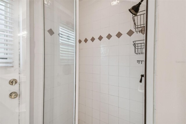 bathroom featuring a shower with shower door