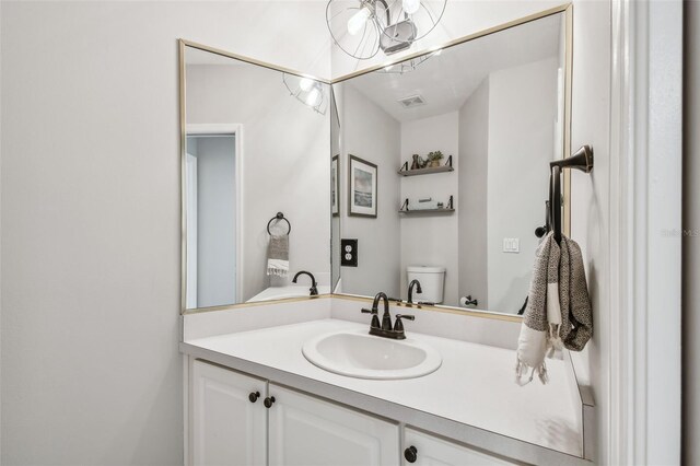 bathroom featuring vanity and toilet