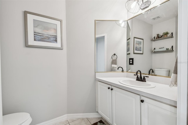 bathroom with tile patterned floors, vanity, and toilet