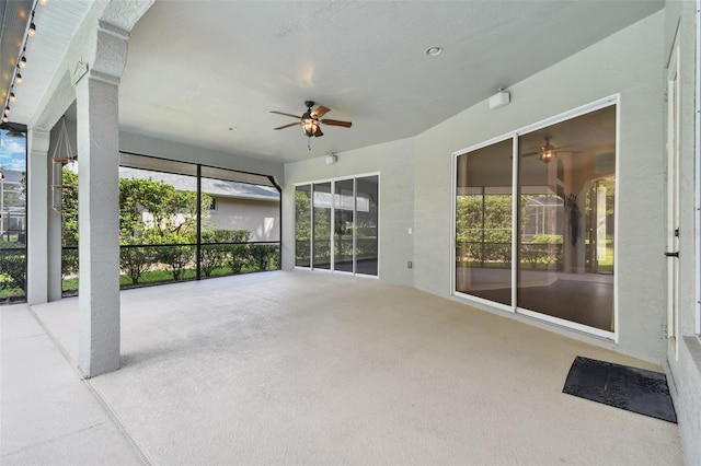 unfurnished sunroom with ceiling fan and a healthy amount of sunlight