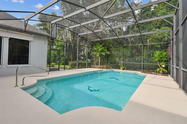 view of swimming pool with glass enclosure and a patio area