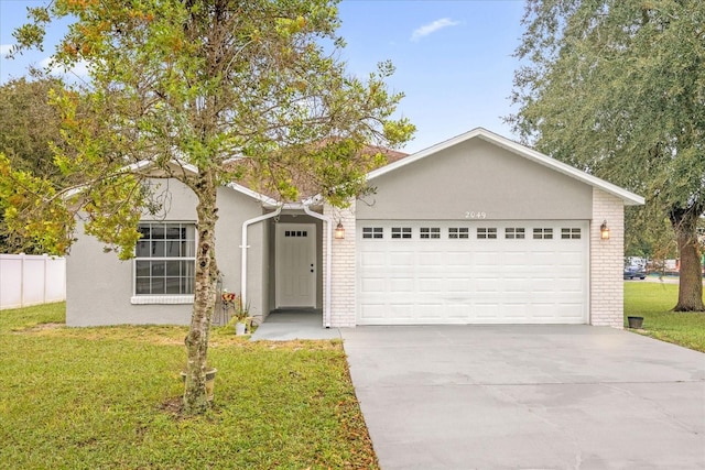 single story home featuring a front lawn and a garage