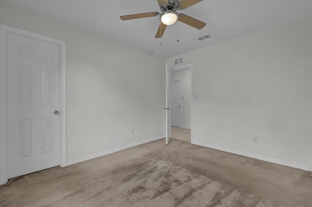 unfurnished room featuring light carpet and ceiling fan