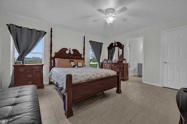 tiled bedroom with connected bathroom and ceiling fan