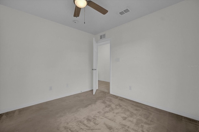 carpeted spare room with ceiling fan