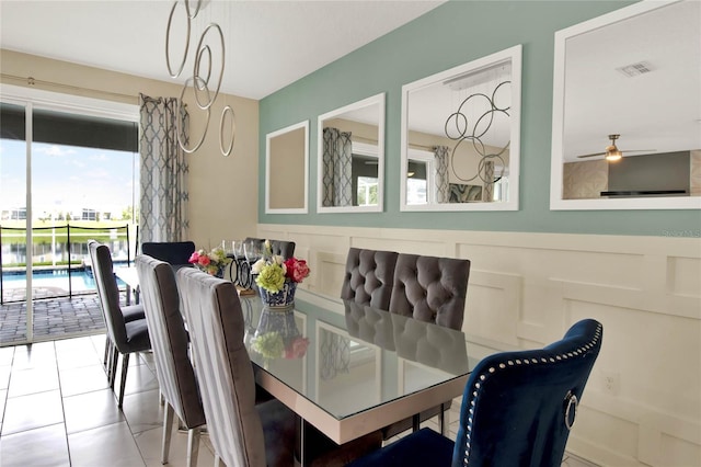 tiled dining room with plenty of natural light and ceiling fan