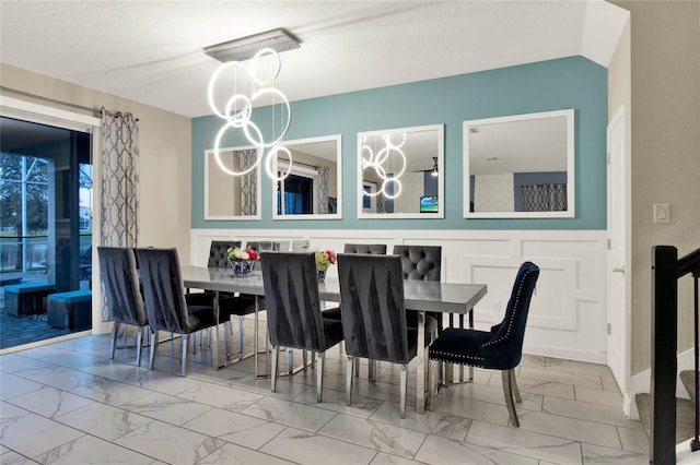 dining space with a chandelier and a textured ceiling